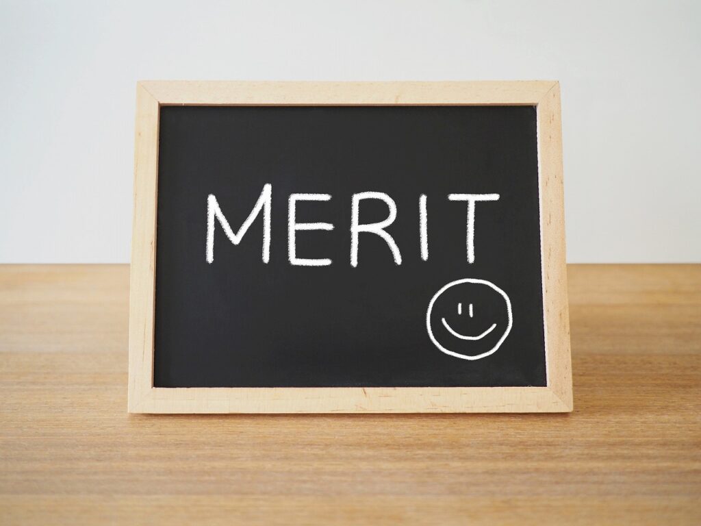 黒板に「MERIT」とスマイルマークが書かれている