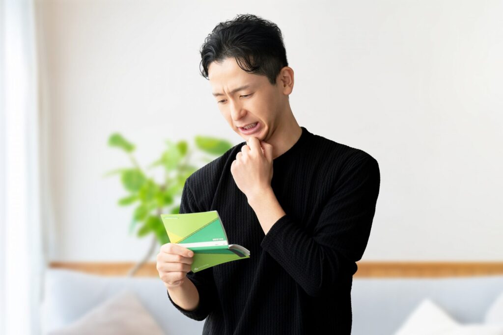 通帳を見る男性